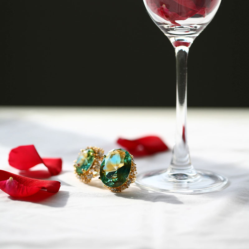 Green glass earrings with golden ear pads