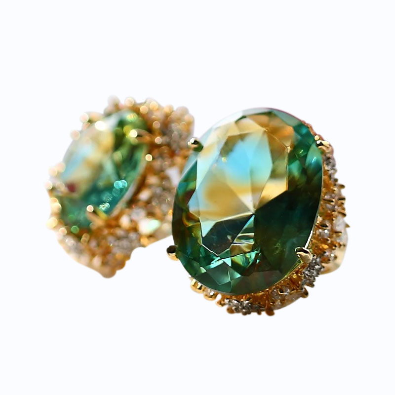Green glass earrings with golden ear pads